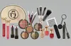 A collection of makeup products arranged on a gray background. Produktbild-Vorschau