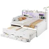 A white bed frame with a pull-out trundle bed, drawers, and a bookshelf headboard with LED lighting. Produktbild-Vorschau