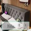 A close-up view of a bed with a tufted headboard, showing integrated charging ports and a tablet. Anteprima dell’immagine prodotto