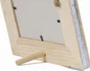 Close-up view of the back of a wooden picture frame, showing the stand. Produktbild-Vorschau