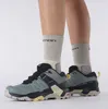 A pair of women's hiking shoes worn by a person. Produktbild-Vorschau