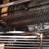 A close-up view of the interior of a microwave oven, showing the heating element and racks. Anteprima dell’immagine prodotto