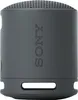 A dark gray Sony SRS-XB100 Bluetooth speaker is shown from the side against a white background. Voir les images du produit