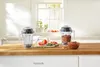 Two blenders and ingredients for salsa are displayed on a kitchen counter. Anteprima dell’immagine prodotto