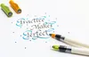 Calligraphy pens and ink dots on a white surface, with the phrase "Practice Makes Perfect" written in calligraphy. Voir les images du produit
