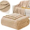 A beige striped blanket is shown folded and draped over a sofa, with a close-up inset of the fabric texture. Anteprima dell’immagine prodotto