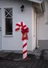 A lighted candy cane decoration is placed outside a house. Podgląd zdjęcia produktu