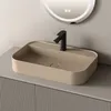 A modern bathroom sink with a black faucet on a vanity. Voir les images du produit