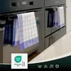 Two blue checkered kitchen towels hanging on oven handles. Produktbild-Vorschau