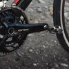A close-up view of a bicycle's crankset and pedal. Produktbild-Vorschau