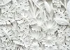 A close-up, detailed view of a white embossed decorative panel featuring a pattern of tropical leaves and flowers. Voir les images du produit