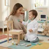 A mother and child are playing doctor in a room with toys. Anteprima dell’immagine prodotto