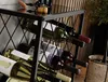 A wine rack filled with bottles of wine, placed in a home or cellar setting. Podgląd zdjęcia produktu