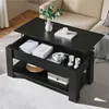 A black lift-top coffee table with storage, set in a living room with a sofa in the background. Produktbild-Vorschau