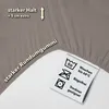 A close-up of a taupe fabric with text and care symbols. Produktbild-Vorschau