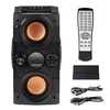 A black portable Bluetooth speaker with two orange speaker cones, a remote control, and charging cables, all laid out on a white background. Podgląd zdjęcia produktu
