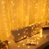 A cozy living room setting with a couch decorated with warm white string lights. Produktbild-Vorschau