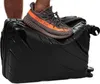 A person's foot wearing a sneaker is pressing down on a black suitcase. Náhled obrázku produktu