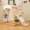 Children playing on a wooden indoor playground set with a slide, climbing net, and ladder. Produktbild-Vorschau