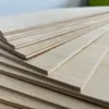 A stack of thin wooden boards, likely plywood, is shown from a close-up, diagonal angle. Produktbild-Vorschau