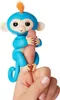 A blue toy monkey is gripping a finger. Anteprima dell’immagine prodotto
