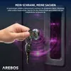 A hand is inserting a key into the lock of a black cabinet. Purple digital graphics are overlaid on the cabinet. Produktbild-Vorschau