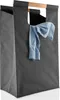 A dark grey laundry bag with a light blue shirt draped over the handle. Produktbild-Vorschau