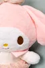 A close-up of a pink plush toy character with white facial features and a pink bow. Podgląd zdjęcia produktu