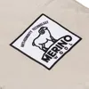A close-up of a patch on a beige fabric. Podgląd zdjęcia produktu