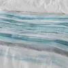 A close-up view of a textured fabric with a wave-like pattern in blue, white, and gray. Produktbild-Vorschau