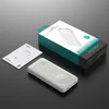 A white power bank, its user manual, and its packaging are arranged on a dark gray surface. Produktbild-Vorschau