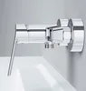 A chrome-finished single-lever shower faucet is mounted on a light gray wall above a white sink. Produktbild-Vorschau