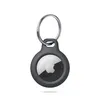 A black Apple AirTag attached to a keychain ring, shown against a white background. Produktbild-Vorschau