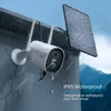 A security camera with a solar panel mounted on a building during a rain shower. Produktbild-Vorschau