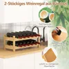A two-tier bamboo wine rack filled with wine bottles, placed on a kitchen counter next to a sink and faucet. Informational callouts highlight the material and craftsmanship. Podgląd zdjęcia produktu