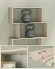Collage showing a beige zig-zag bookshelf with two 10kg kettlebells, a close-up of a shelf bracket, and a close-up of shelf thickness. Náhled obrázku produktu