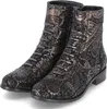 A pair of black ankle boots with a gold paisley pattern. Produktbild-Vorschau