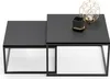 Two nesting coffee tables with decorative items on one of them.