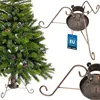 A Christmas tree stand is shown next to a decorated Christmas tree. Náhled obrázku produktu