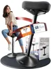A woman is sitting on an ergonomic stool, with promotional stickers and packaging visible. Produktbild-Vorschau