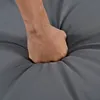 A hand is pressing into a gray cushioned surface. Podgląd zdjęcia produktu