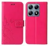A pink flip phone case with a floral and butterfly design is shown open, revealing the inside of the case and the phone it is designed to protect. The phone's camera module is visible on the right side of the image. Produktbild-Vorschau