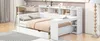 A modern white daybed with integrated shelving and storage drawers, set up in a bedroom environment. Produktbild-Vorschau