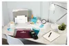 A desk setup with office supplies, including file folders, a label maker, a coffee cup, a lamp, and a notebook. Produktbild-Vorschau