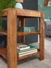 A close-up shot of a wooden shelf unit with books and a decorative box. Podgląd zdjęcia produktu