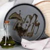 A close-up view of a cast iron pan with oil drizzled on it, next to a glass bottle of olive oil. Produktbild-Vorschau
