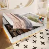 A white upholstered bed frame with storage compartments visible underneath the mattress, decorated with blankets and pillows.