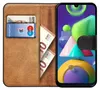 A book-style phone case with a Samsung Galaxy M30s M21 phone inside, showing cards and banknotes in the case. Produktbild-Vorschau