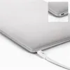 A close-up shot of a white USB-C cable plugged into a silver laptop. Produktbild-Vorschau