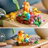 Two images showing a LEGO Creator bird's nest set with toy birds and eggs, decorated with pink flowers. Produktbild-Vorschau